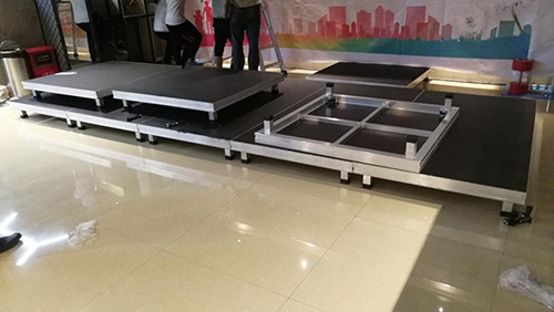 Stage floor material installation methods